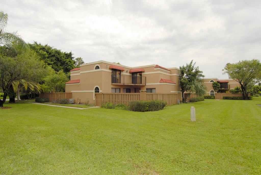 8122 Severn Drive, Unit A Boca Raton, FL 33433 - Photo 1 of 30 a view of a house with a big yard and large trees