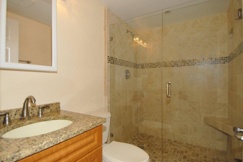 8122 Severn Drive, Unit A Boca Raton, FL 33433 - Photo 15 of 30 a bathroom with a granite countertop sink toilet and shower
