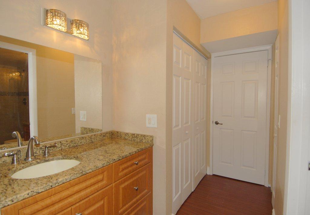 8122 Severn Drive, Unit A Boca Raton, FL 33433 - Photo 16 of 30 a bathroom with a granite countertop sink and a mirror