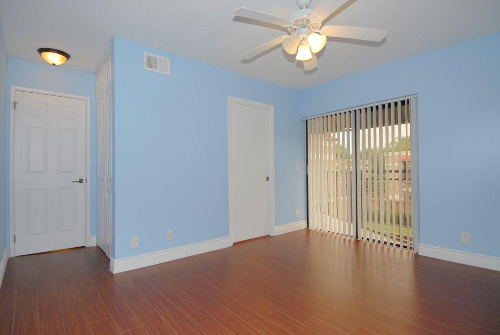8122 Severn Drive, Unit A Boca Raton, FL 33433 - Photo 17 of 30 wooden floor in an empty room with a window
