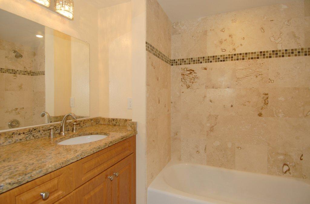 8122 Severn Drive, Unit A Boca Raton, FL 33433 - Photo 19 of 30 a bathroom with a granite countertop sink and a bathtub