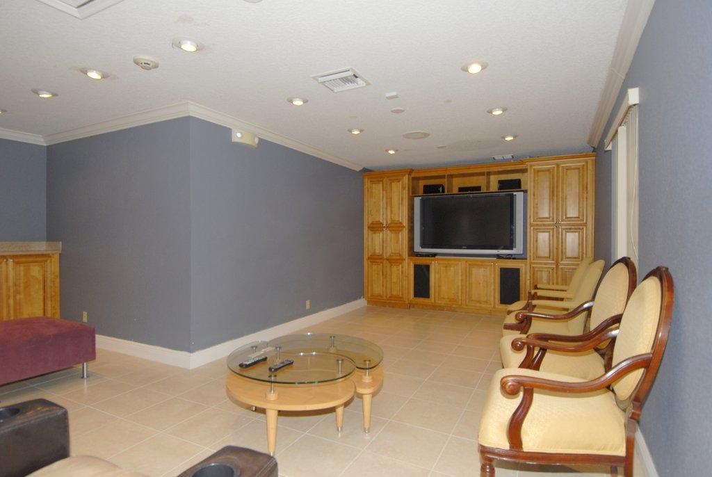8122 Severn Drive, Unit A Boca Raton, FL 33433 - Photo 26 of 30 a living room with furniture and a flat screen tv