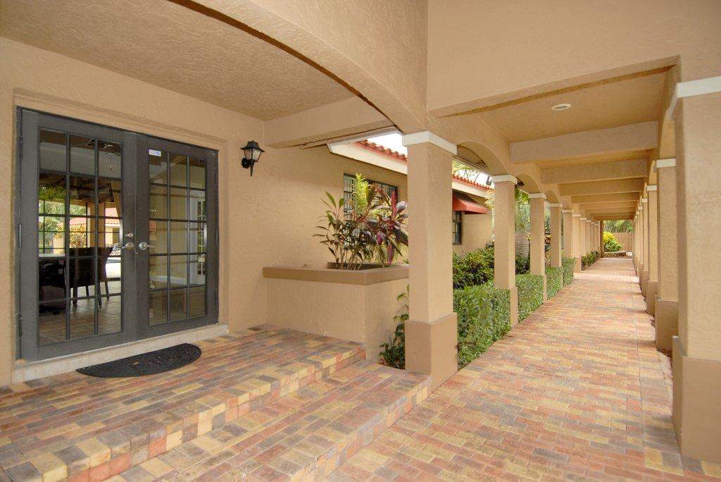 8122 Severn Drive, Unit A Boca Raton, FL 33433 - Photo 27 of 30 a view of a hallway with wooden shelves