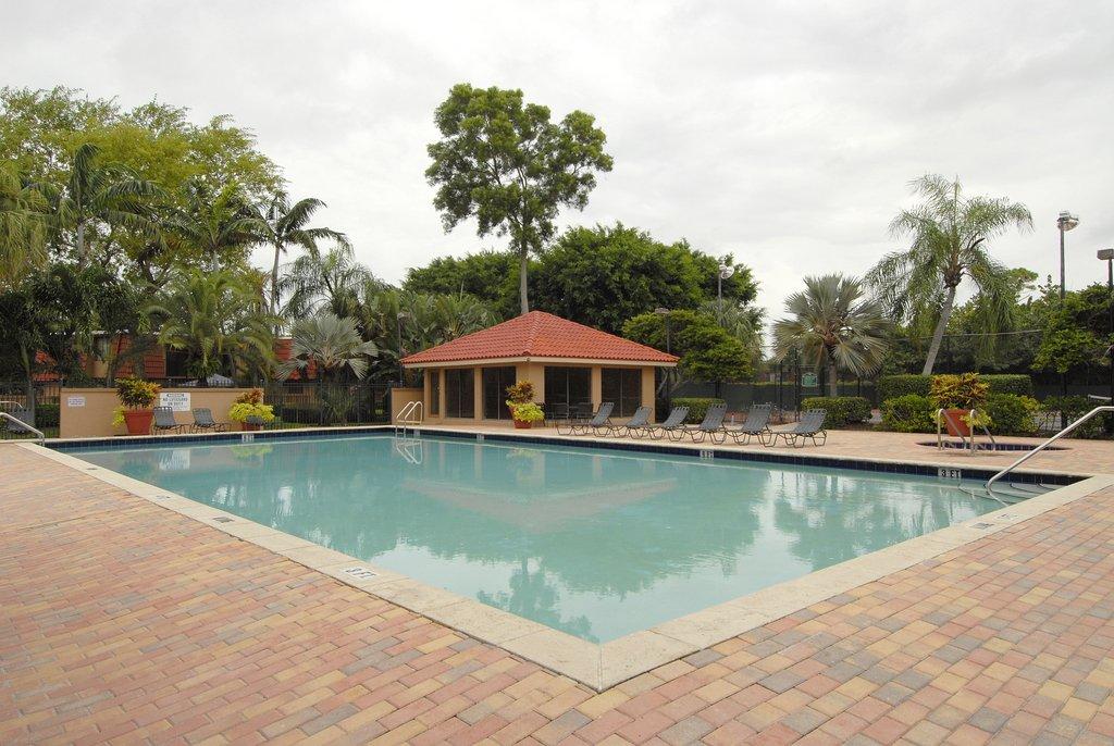 8122 Severn Drive, Unit A Boca Raton, FL 33433 - Photo 29 of 30 a view of a swimming pool with lounge chairs