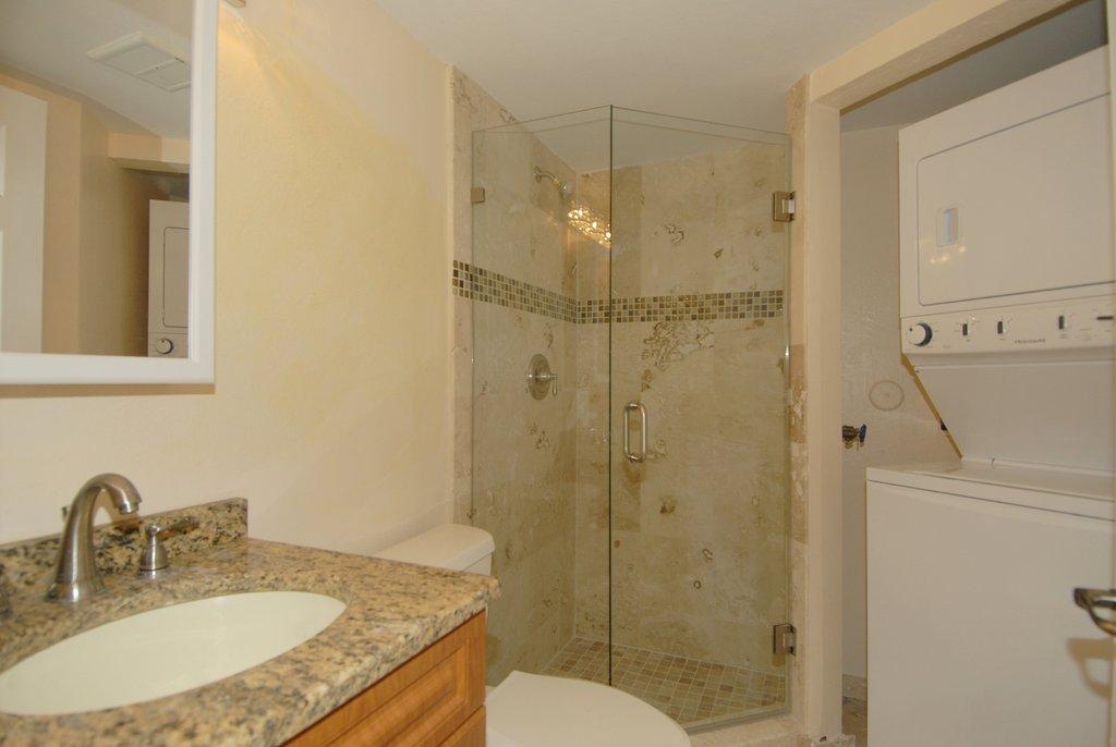 8122 Severn Drive, Unit A Boca Raton, FL 33433 - Photo 10 of 30 a bathroom with a granite countertop shower sink vanity and mirror