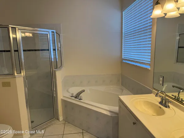 a bathroom with a granite countertop shower a toilet and a sink