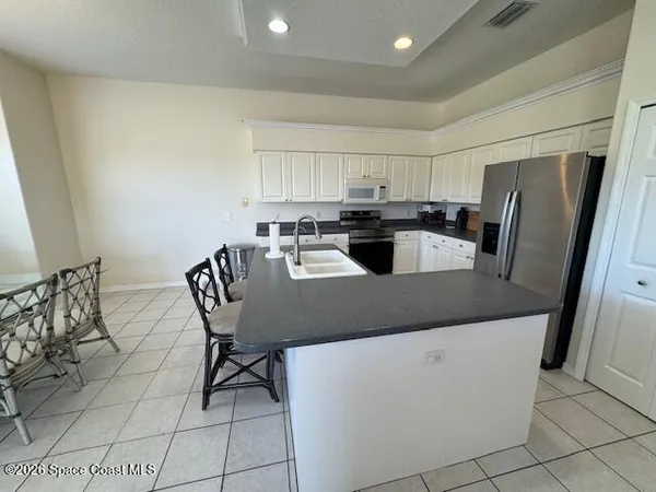 a kitchen with refrigerator and cabinets