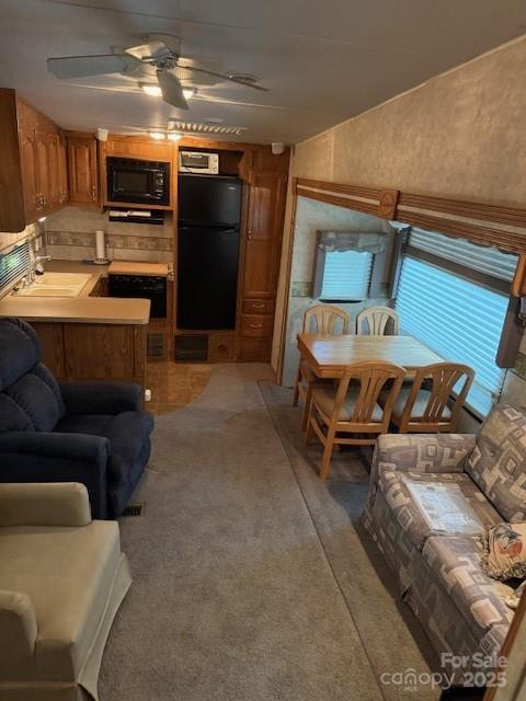 203 River Ridge Trail Mount Gilead, NC 27306 - Photo 5 of 9 a living room with furniture and a flat screen tv