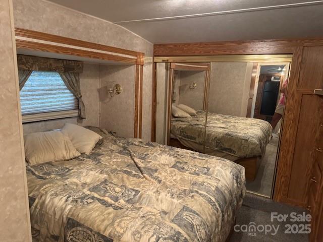 203 River Ridge Trail Mount Gilead, NC 27306 - Photo 7 of 9 a bedroom with a bed and a walk in closet