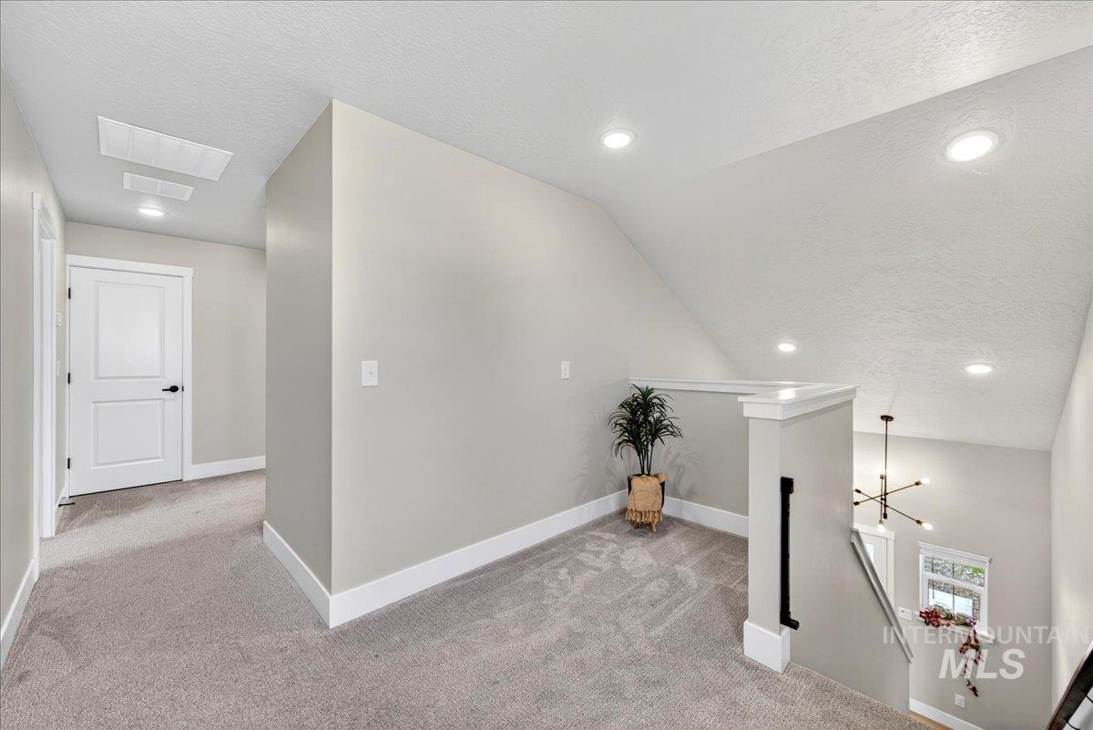 6025 South Catria Place Meridian, ID 83642 - Photo 15 of 34 Hallway with recessed lighting, light colored carpet, and an upstairs landing