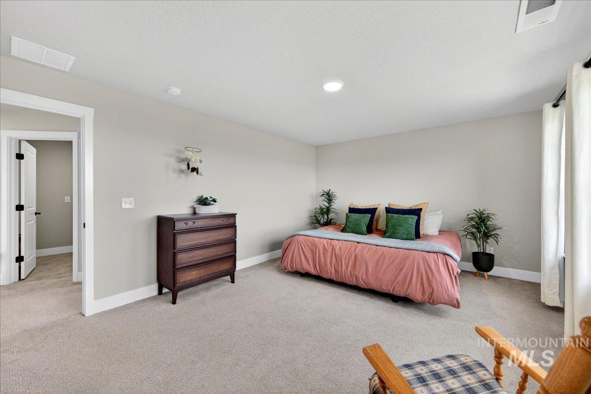 6025 South Catria Place Meridian, ID 83642 - Photo 17 of 34 Bedroom with baseboards and light carpet