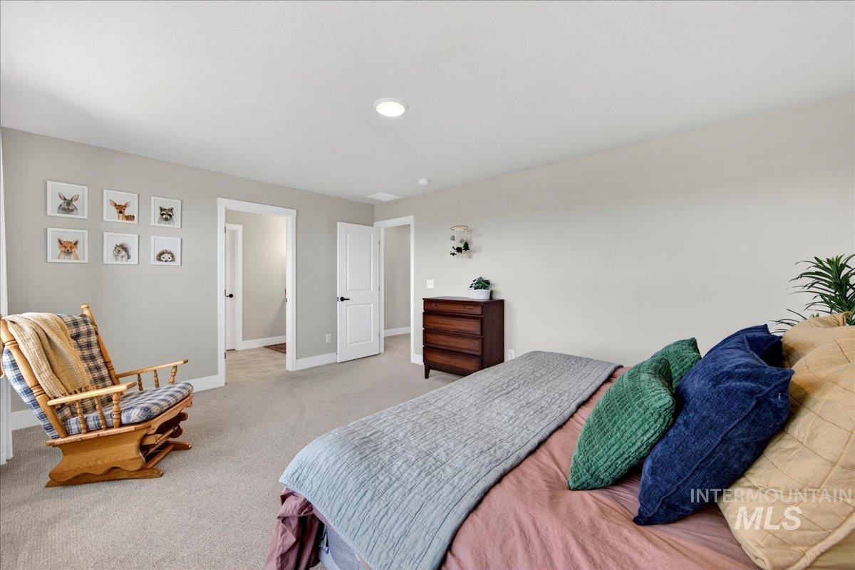 6025 South Catria Place Meridian, ID 83642 - Photo 18 of 34 Bedroom with light colored carpet and baseboards