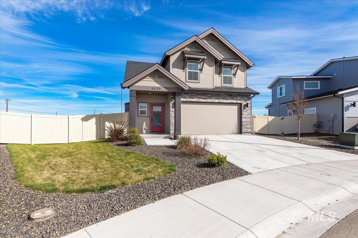 6025 South Catria Place Meridian, ID 83642 - Photo 2 of 34 Craftsman-style house featuring an attached garage, driveway, a gate, and stone siding