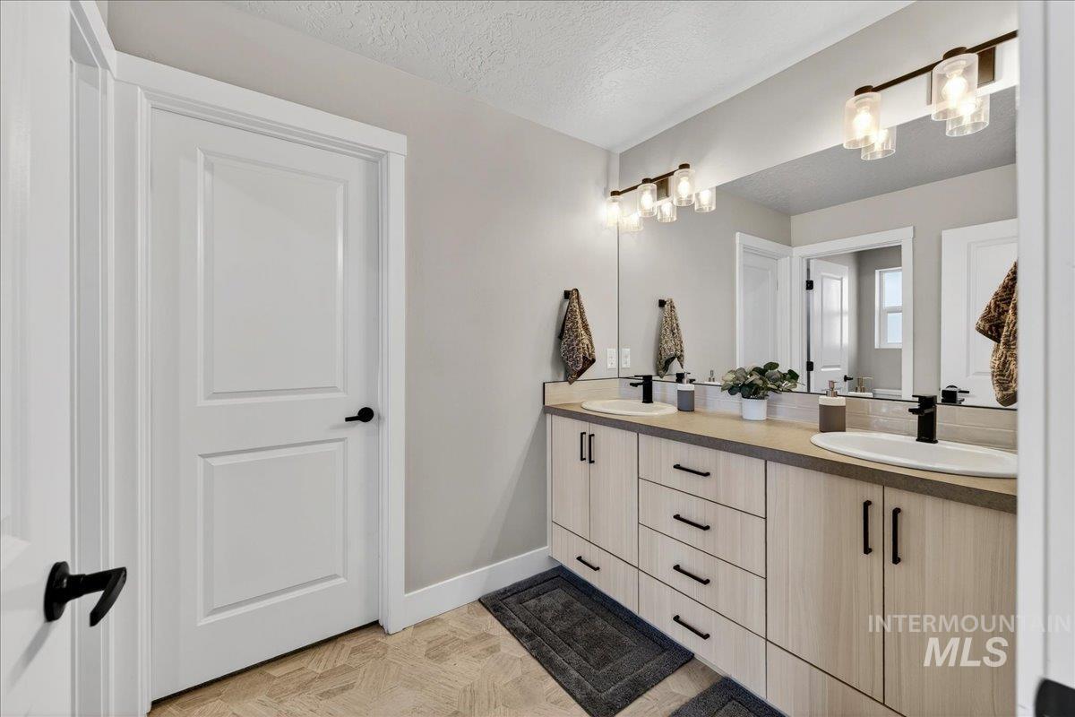 6025 South Catria Place Meridian, ID 83642 - Photo 19 of 34 Full bathroom featuring double vanity and a textured ceiling