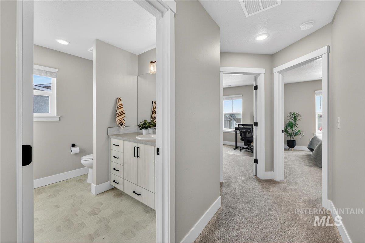 6025 South Catria Place Meridian, ID 83642 - Photo 22 of 34 Hallway with an office area and light carpet