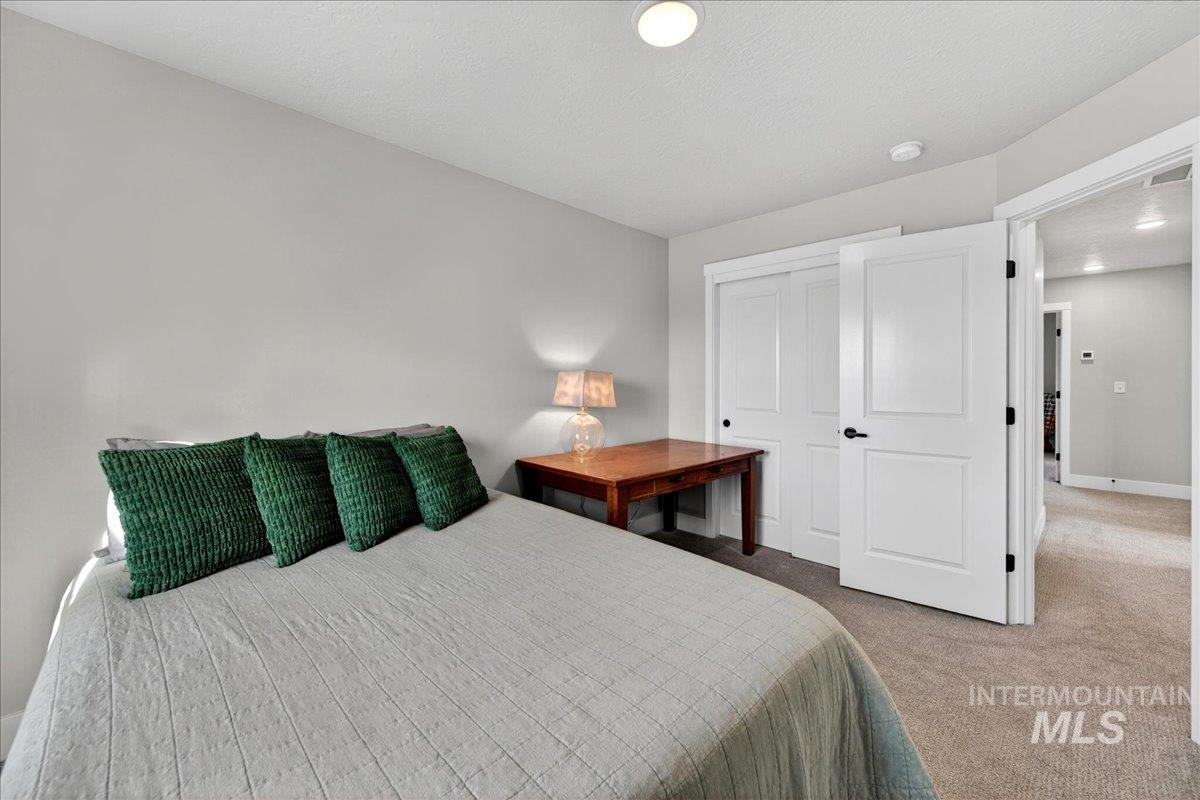 6025 South Catria Place Meridian, ID 83642 - Photo 24 of 34 Carpeted bedroom featuring a closet and a textured ceiling