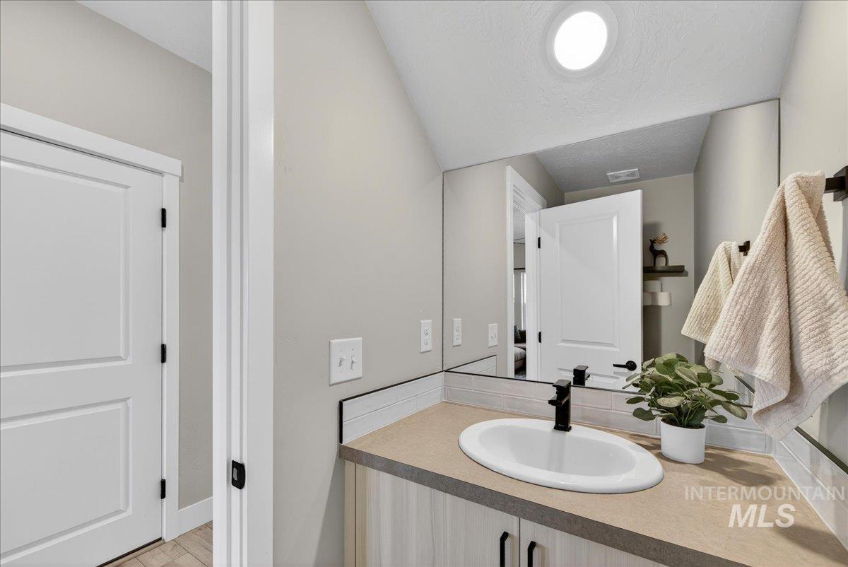 6025 South Catria Place Meridian, ID 83642 - Photo 27 of 34 Bathroom with vanity and a textured ceiling