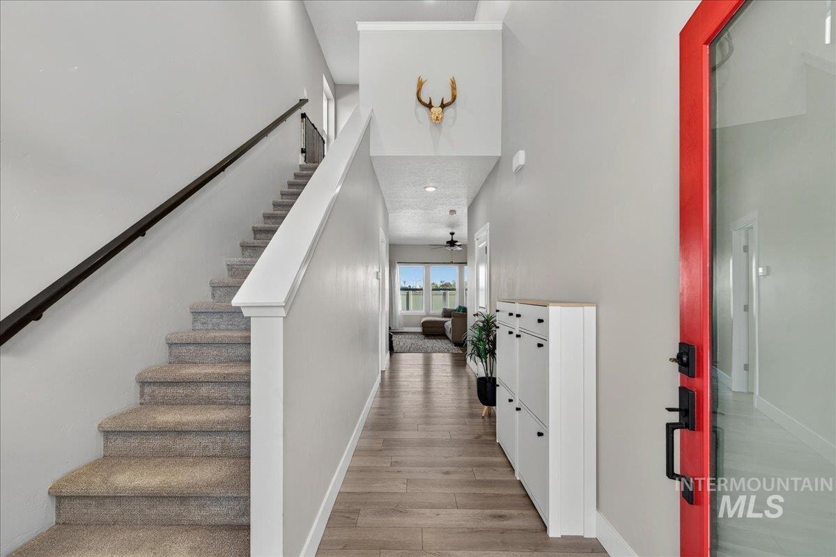 6025 South Catria Place Meridian, ID 83642 - Photo 3 of 34 Hall featuring light wood-type flooring, a high ceiling, and recessed lighting