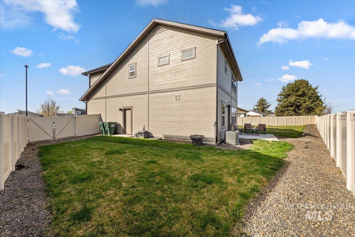 6025 South Catria Place Meridian, ID 83642 - Photo 32 of 34 Back of house with a fenced backyard, a patio area, and a gate