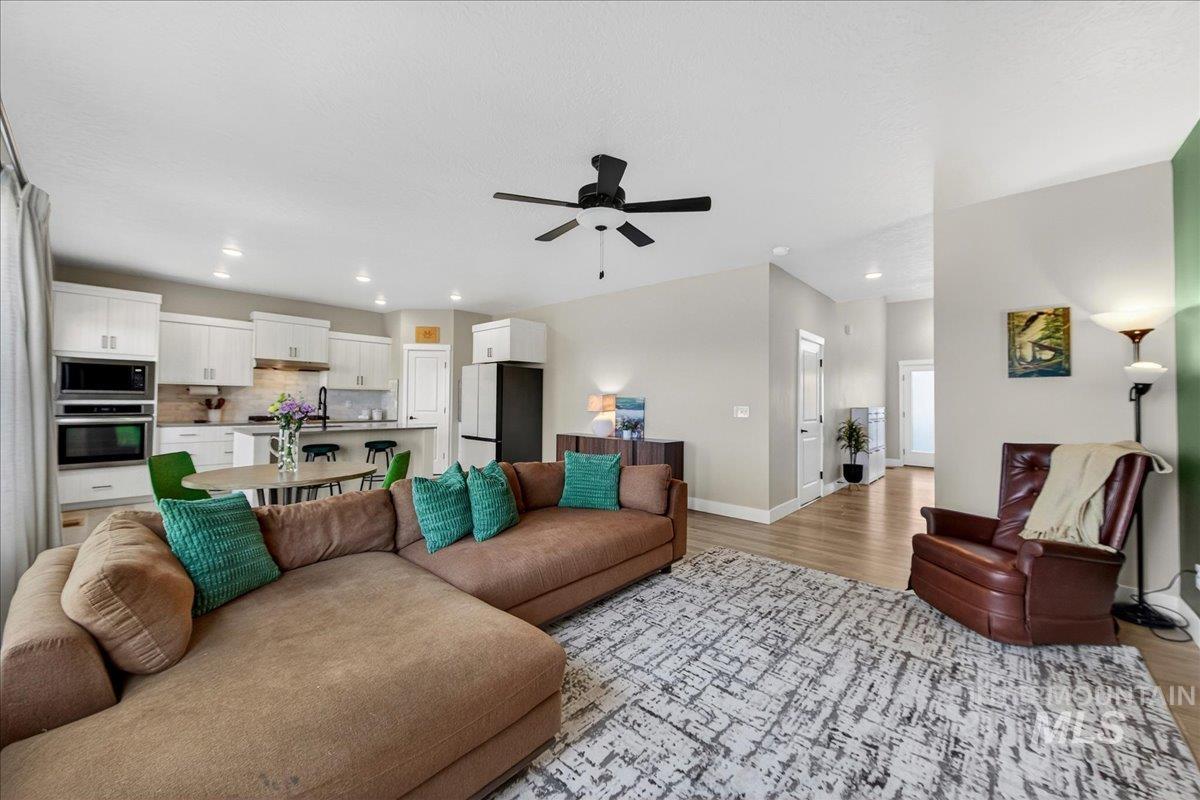 6025 South Catria Place Meridian, ID 83642 - Photo 6 of 34 Living room featuring ceiling fan, light wood-style floors, and recessed lighting