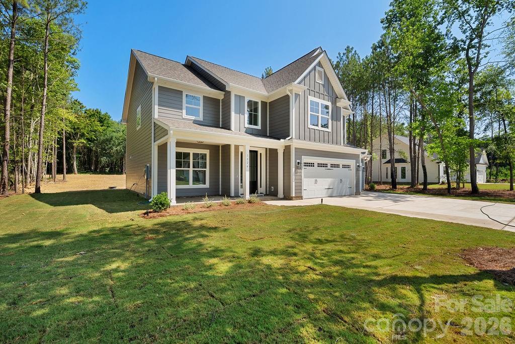 1024 Baylor Grove Road, Unit 19 Monroe, NC 28112 - Photo 3 of 47 a front view of a house with a garden