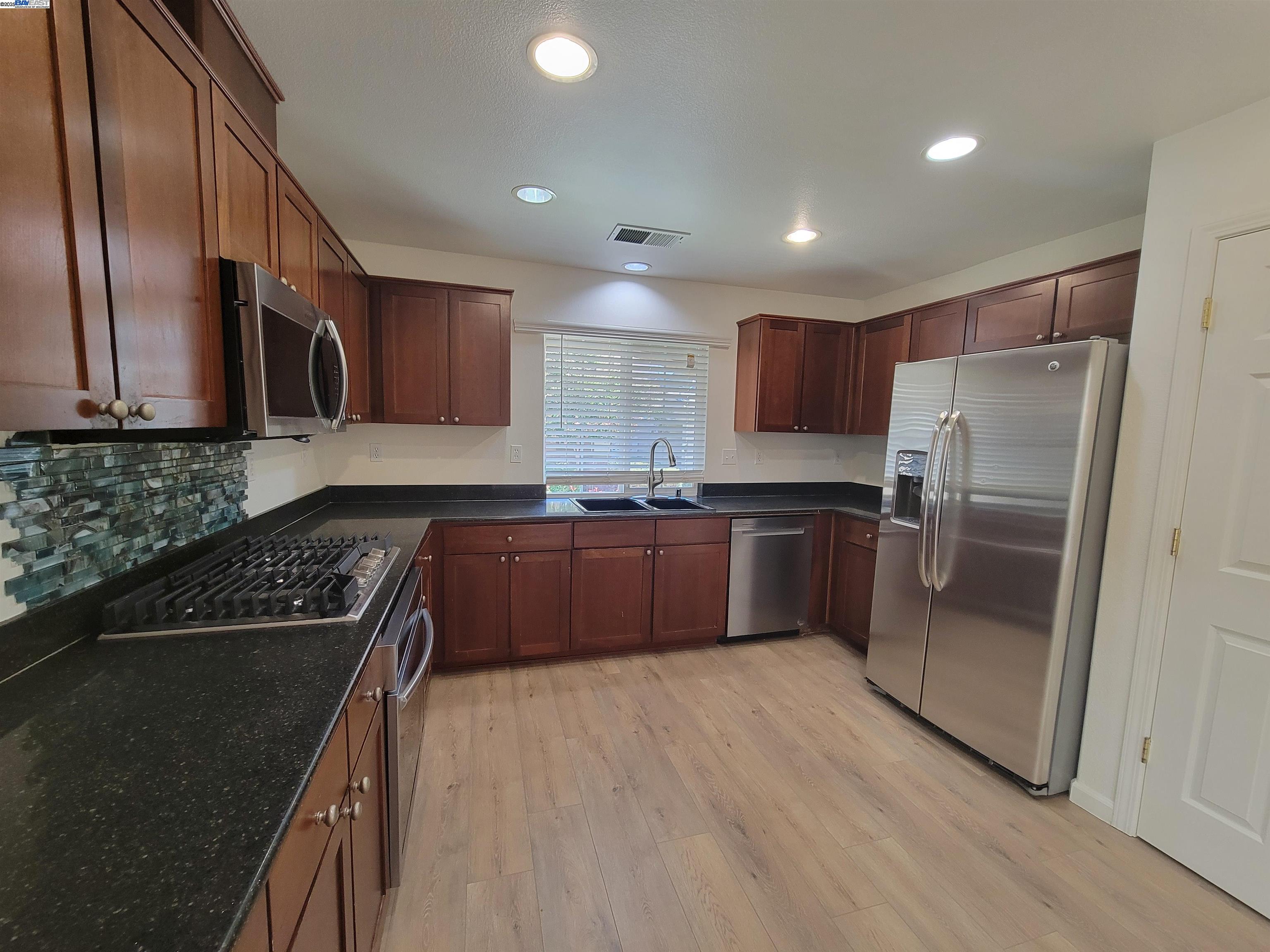 313 Turnstone Circle Pittsburg, CA 94565 - Photo 11 of 16 a kitchen with granite countertop stainless steel appliances and wooden cabinets