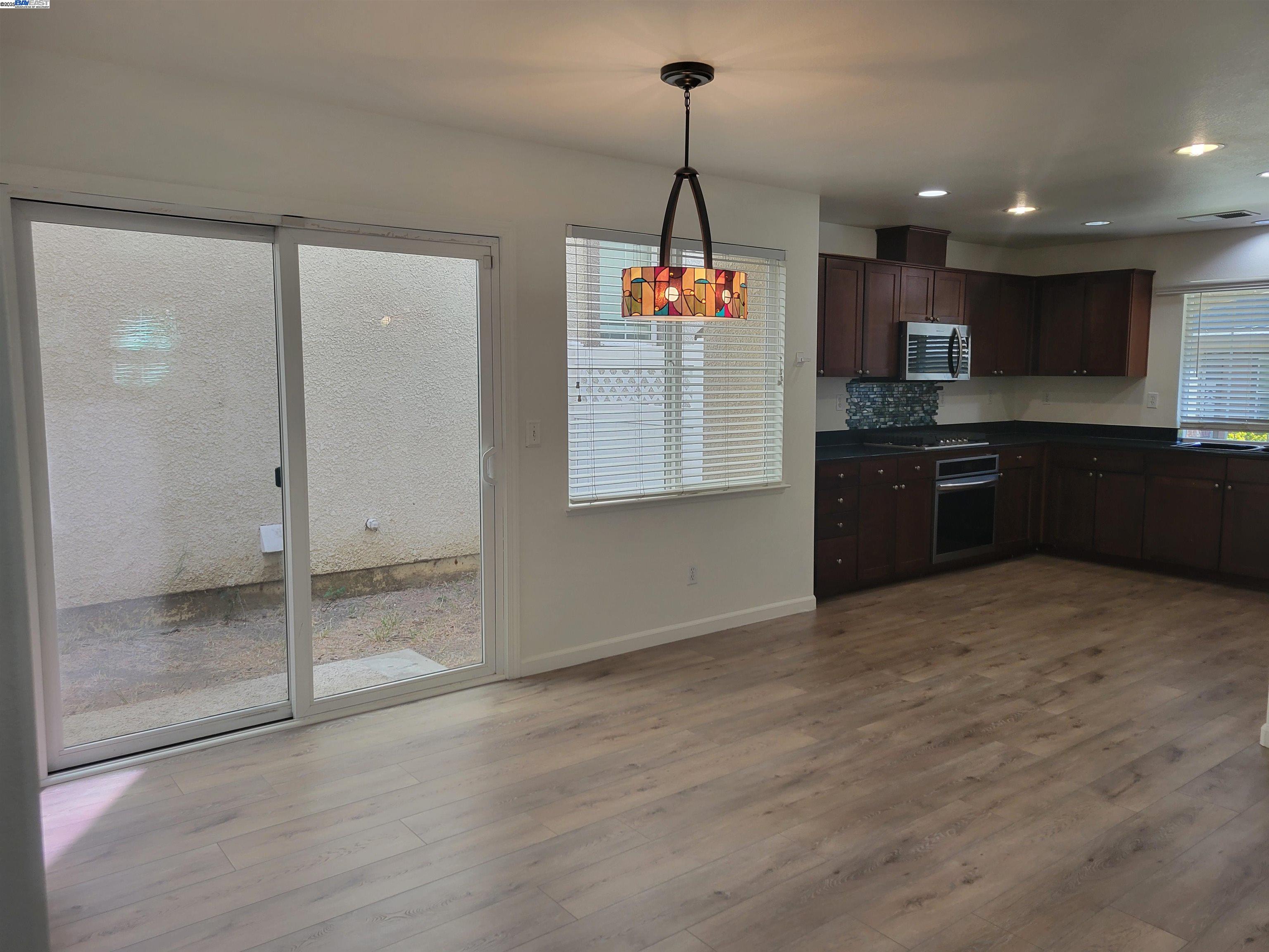 313 Turnstone Circle Pittsburg, CA 94565 - Photo 13 of 16 a kitchen with stainless steel appliances granite countertop a sink and a refrigerator