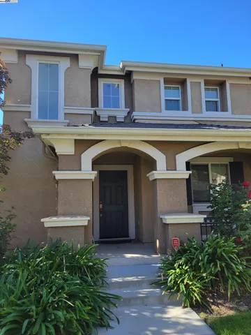 a view of a house with a small yard