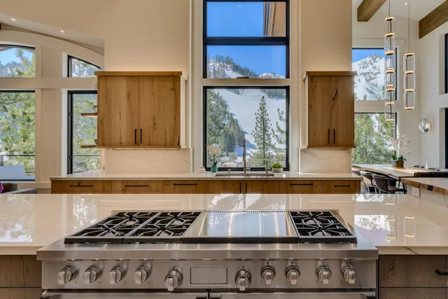a kitchen with a stove a window and cabinets