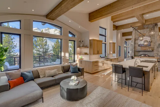 a living room with fireplace furniture and a large window