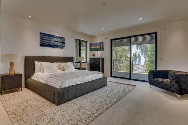 a spacious bedroom with a large bed and a large window