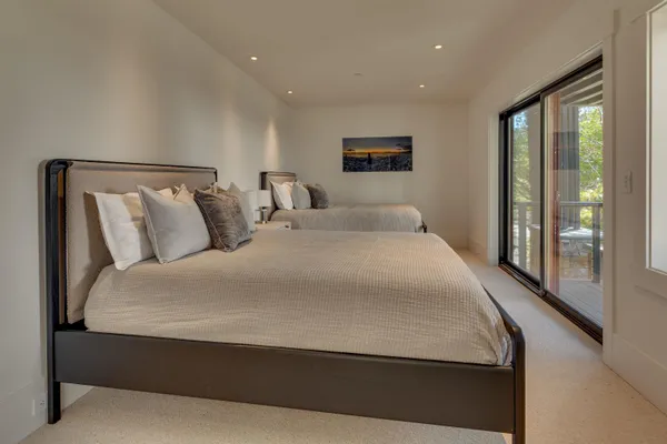 a large bed sitting in a bedroom next to a balcony