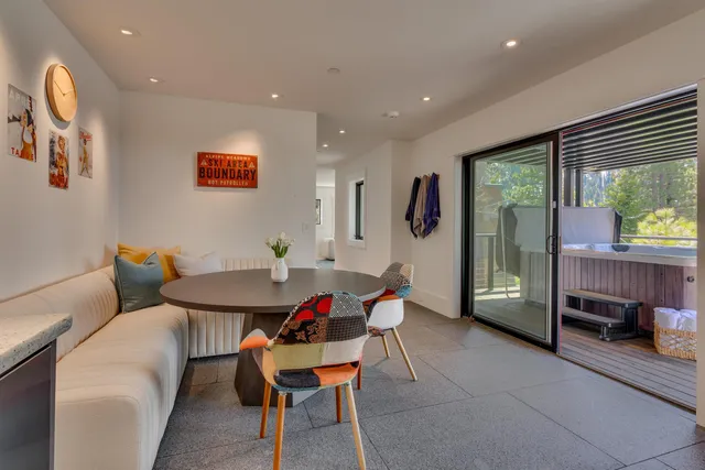 a dining room with furniture and a floor to ceiling window