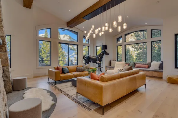 a living room with furniture chandelier and a large window
