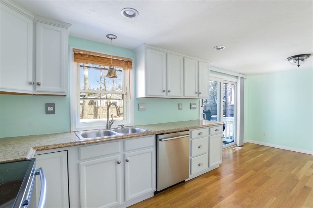 48 Kennedy Circle Barnstable, MA 02601 - Photo 14 of 32 a kitchen with a sink cabinets window and stainless steel appliances