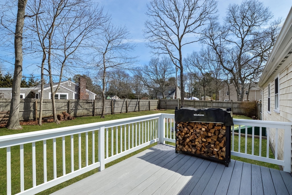 48 Kennedy Circle Barnstable, MA 02601 - Photo 17 of 32 a balcony with wooden floor and trees