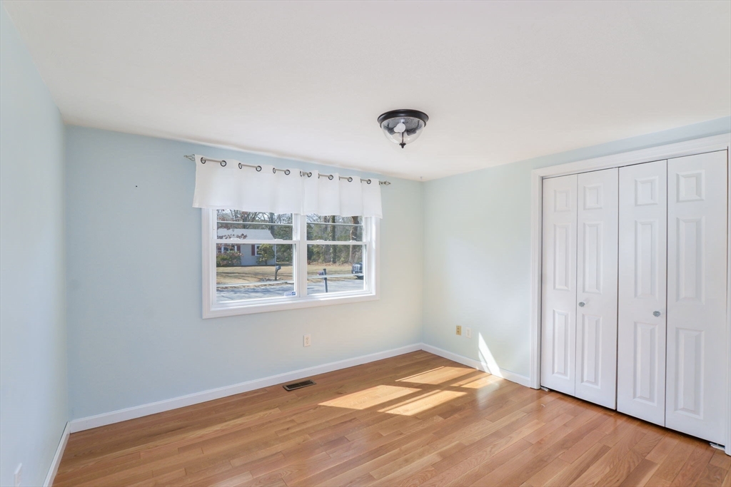 48 Kennedy Circle Barnstable, MA 02601 - Photo 18 of 32 a view of an empty room with wooden floor and a window