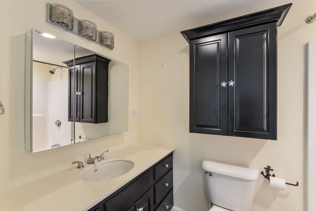 48 Kennedy Circle Barnstable, MA 02601 - Photo 20 of 32 a bathroom with a sink a toilet and shower