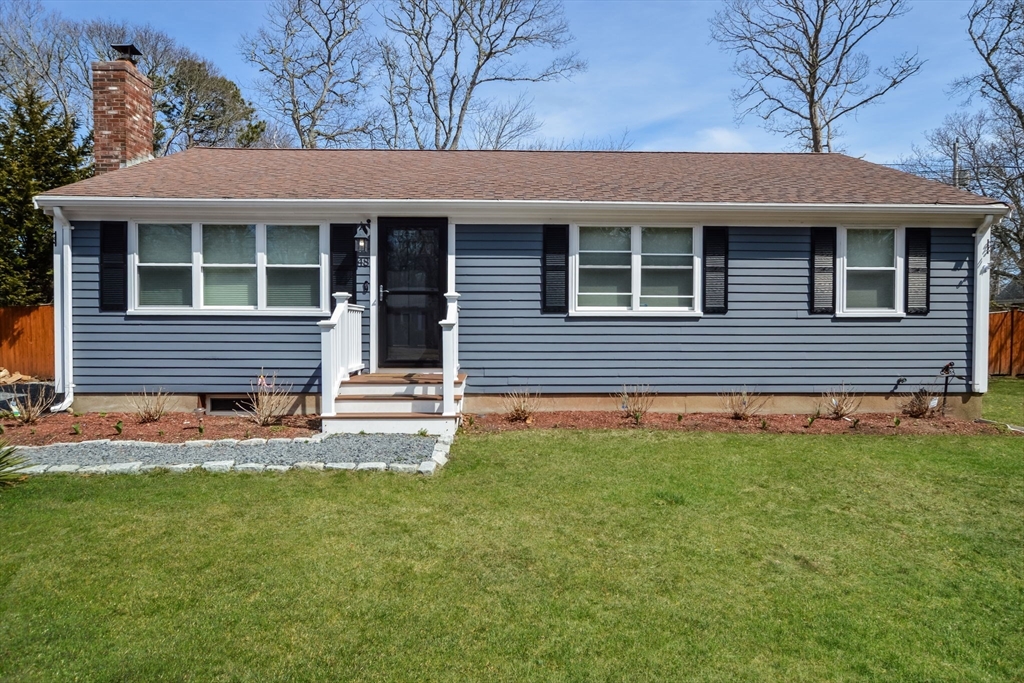 48 Kennedy Circle Barnstable, MA 02601 - Photo 2 of 32 a front view of a house with a yard and outdoor seating