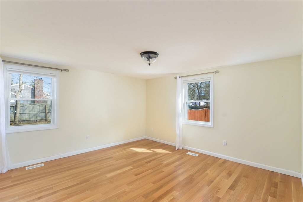 48 Kennedy Circle Barnstable, MA 02601 - Photo 23 of 32 a view of an empty room with wooden floor and a window