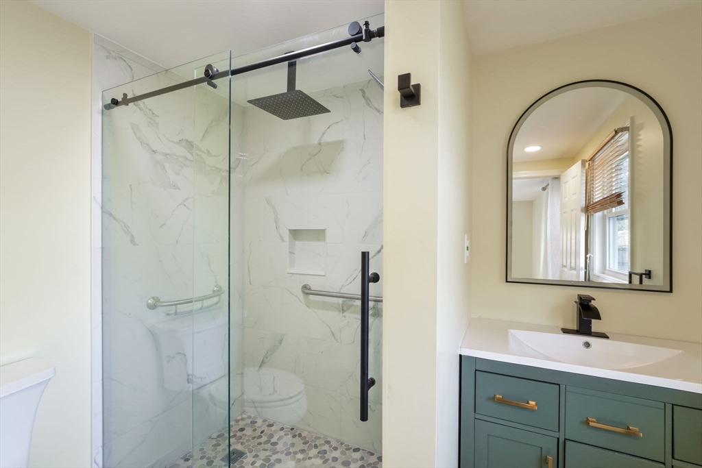 48 Kennedy Circle Barnstable, MA 02601 - Photo 27 of 32 a bathroom with a shower sink and mirror