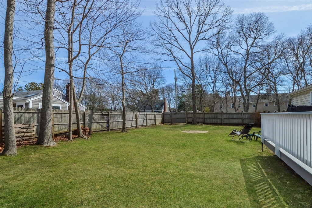 48 Kennedy Circle Barnstable, MA 02601 - Photo 28 of 32 a view of a yard with wooden fence