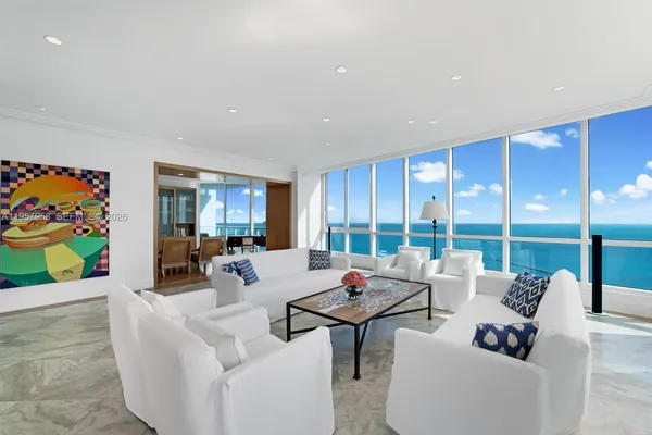 a living room with furniture and a floor to ceiling window