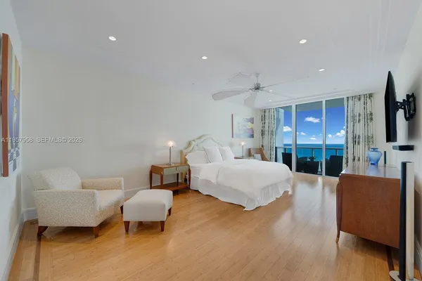 a spacious bedroom with a bed and a couch