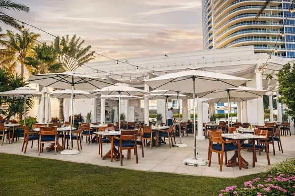 a view of a big yard with table and chairs