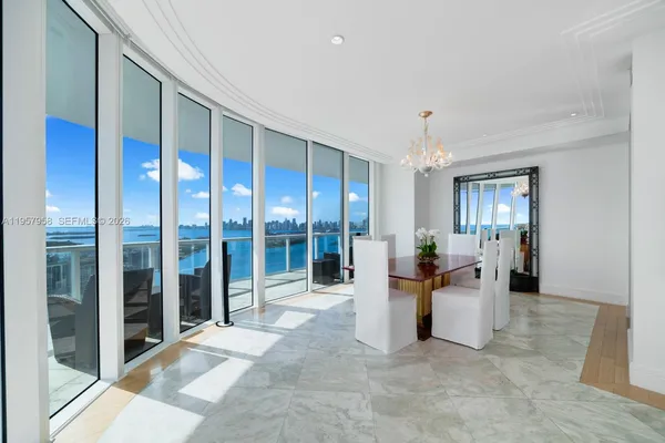 a view of a big room with windows and kitchen view