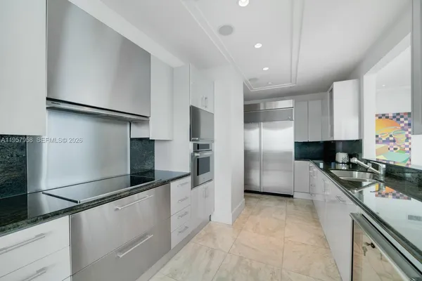 a large kitchen with cabinets and stainless steel appliances