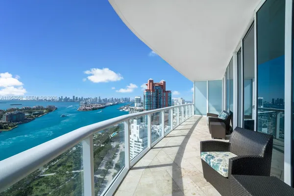 a view of a balcony with couches and wooden floor