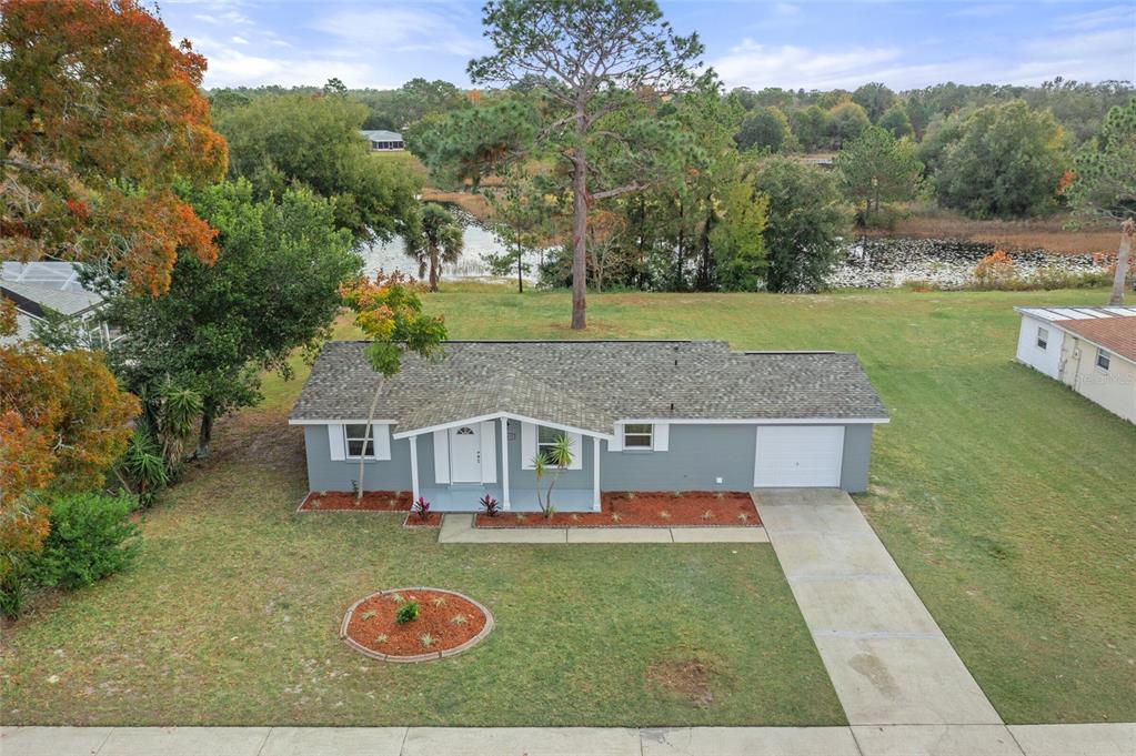 a aerial view of a house with swimming pool and a yard