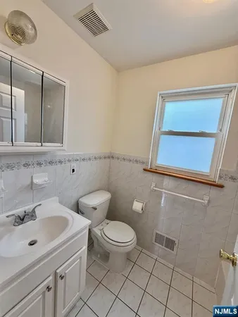 a white toilet sitting next to a bathroom sink